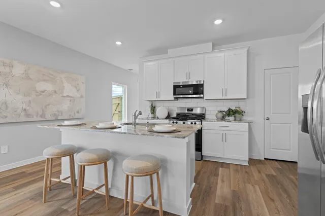 a kitchen with cabinets a sink and appliances