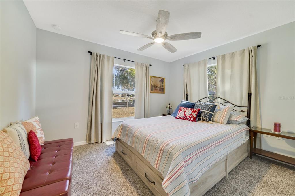 1239 St Anne Shrine Road Lake Wales, FL 33898 - Photo 11 of 27 a bedroom with a bed chandelier and a window