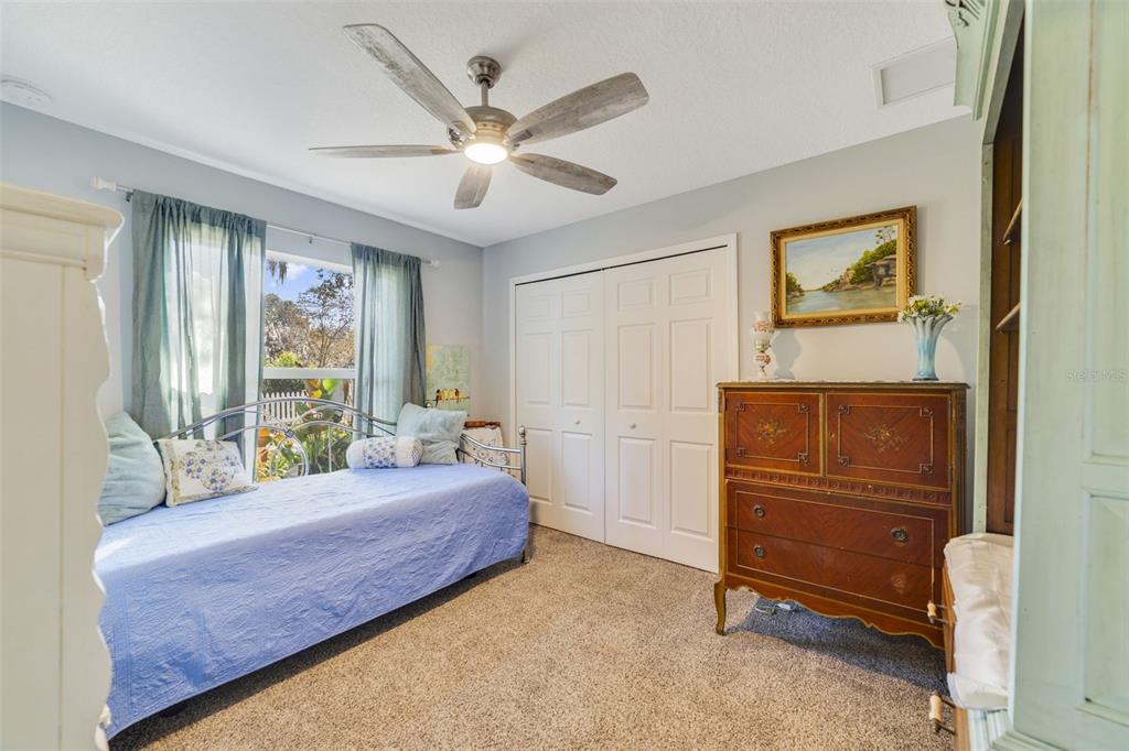 1239 St Anne Shrine Road Lake Wales, FL 33898 - Photo 13 of 27 a bedroom with a bed and a chandelier