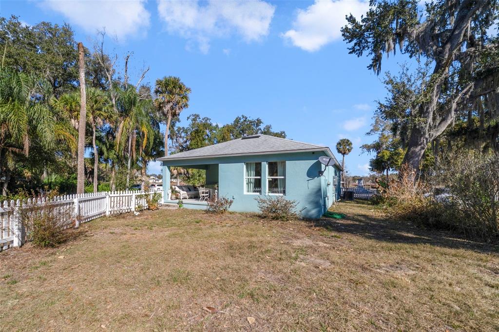 1239 St Anne Shrine Road Lake Wales, FL 33898 - Photo 16 of 27 a backyard of a house with table and chairs