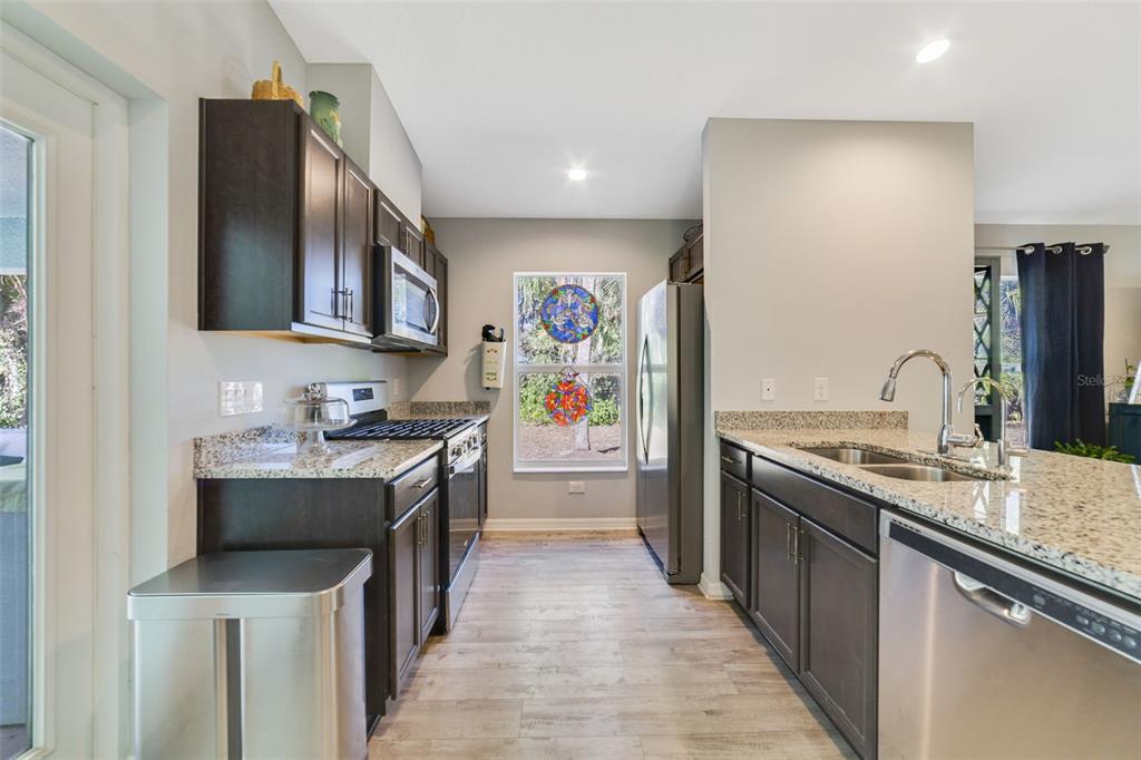 1239 St Anne Shrine Road Lake Wales, FL 33898 - Photo 5 of 27 a kitchen with stainless steel appliances granite countertop a sink stove and refrigerator