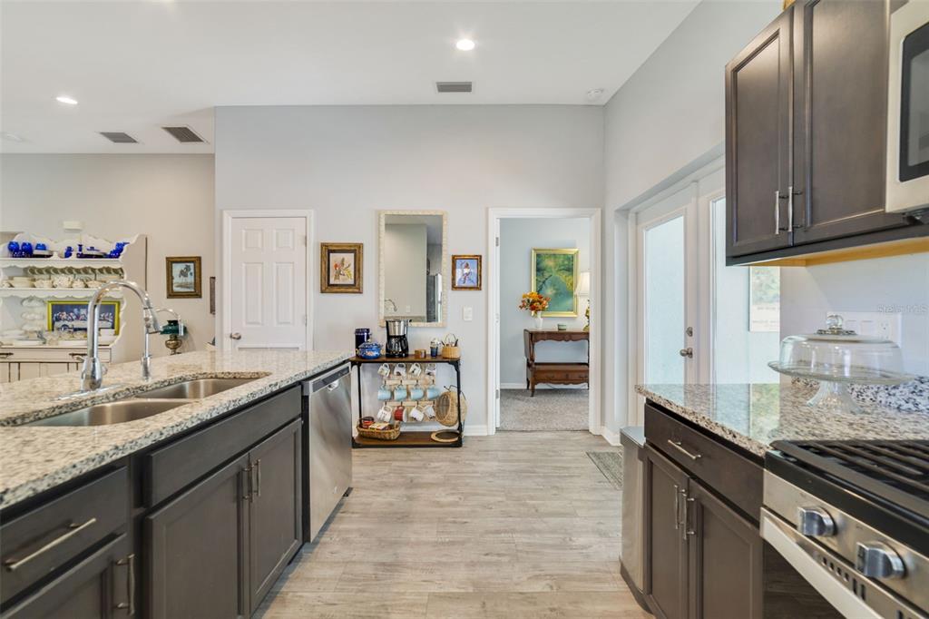 1239 St Anne Shrine Road Lake Wales, FL 33898 - Photo 6 of 27 a large kitchen with granite countertop a sink and cabinets