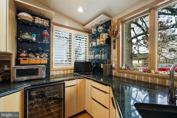 a kitchen with a stove a sink and a microwave