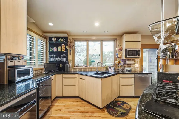 a kitchen with stainless steel appliances a stove sink and cabinets