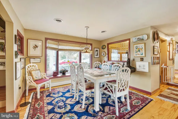 a view of a dining room with furniture wooden floor and a chandelier