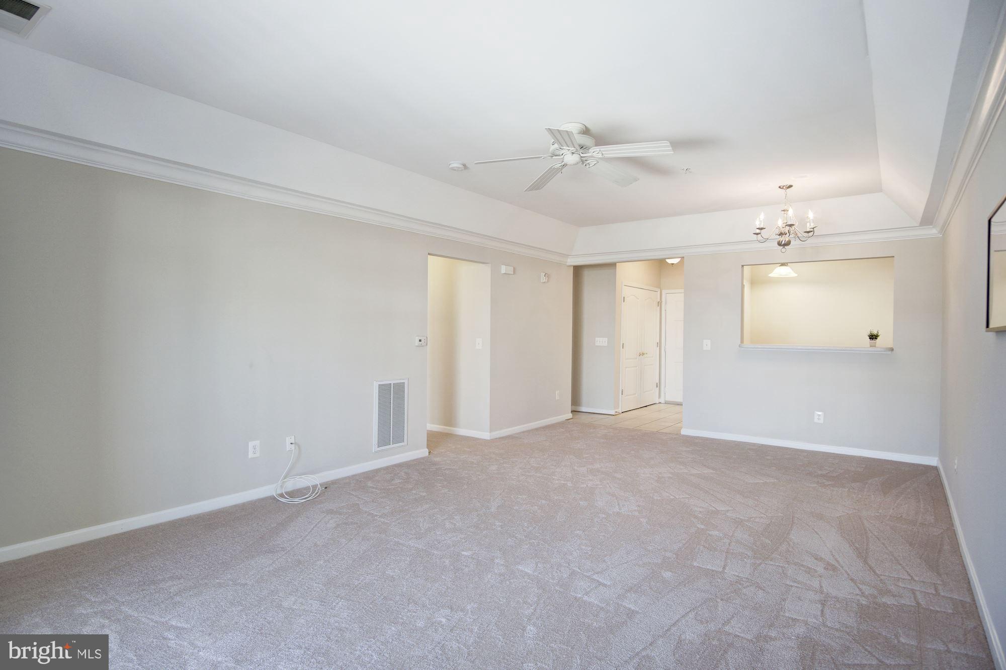7325 Brookview Road, Unit 308 Elkridge, MD 21075 - Photo 14 of 31 Living room and dining room features tray ceiling