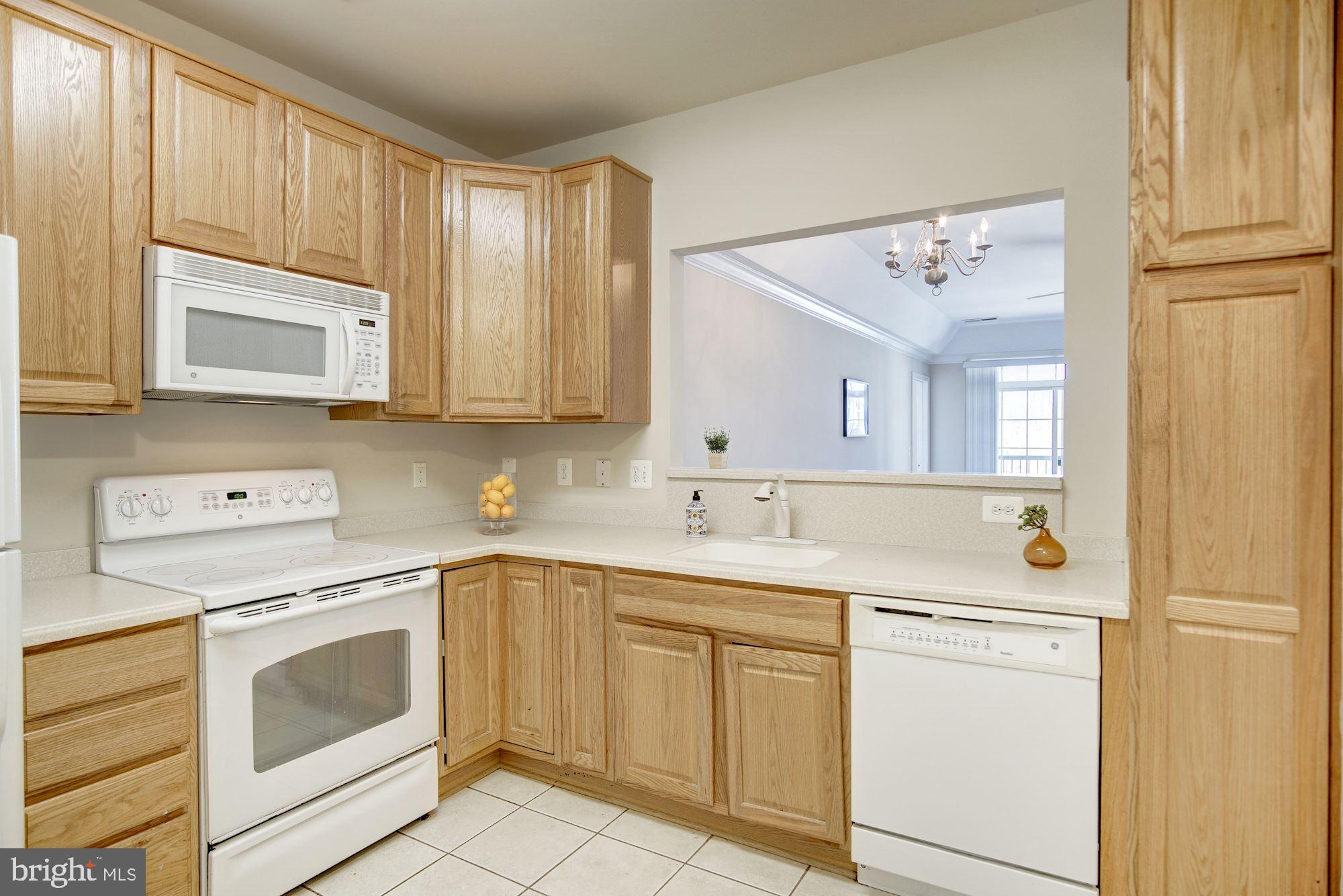 7325 Brookview Road, Unit 308 Elkridge, MD 21075 - Photo 5 of 31 White appliances including built-in microwave