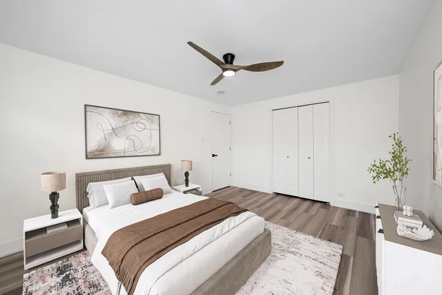 a bedroom with a large bed and a chandelier