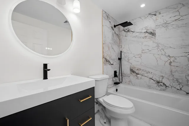 a bathroom with a sink a toilet and a mirror