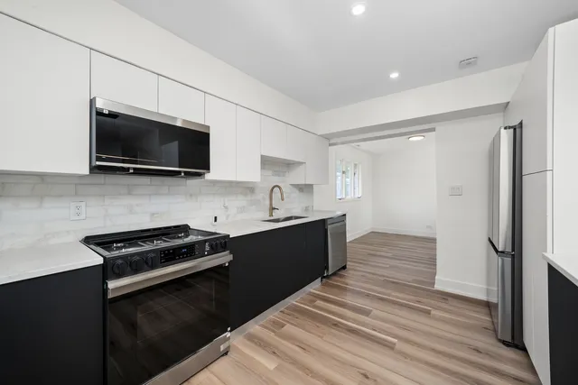 a kitchen with a refrigerator stove and microwave