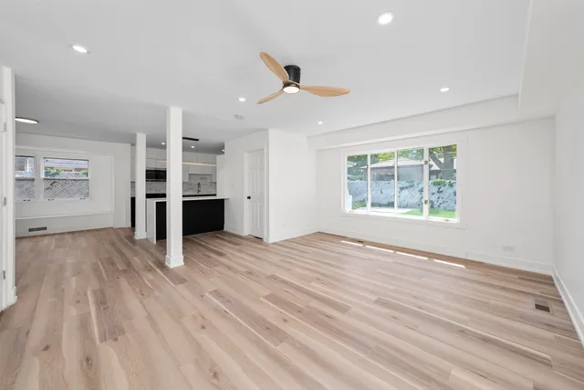 an empty room with a wooden floor and a window