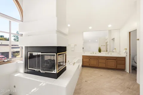 a kitchen with stainless steel appliances kitchen island granite countertop a stove a sink and a microwave