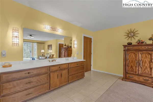 a spacious bathroom with a granite countertop sink and a mirror