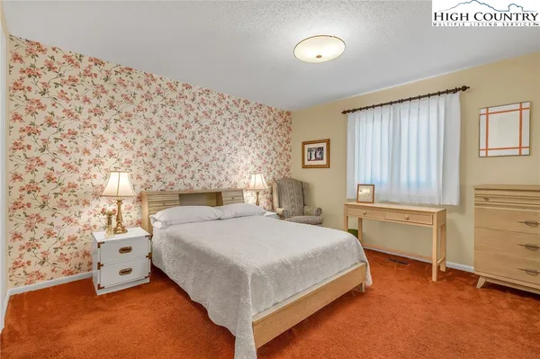 a bedroom with a bed and a table