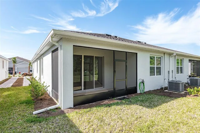 a view of a house with backyard porch and sitting area