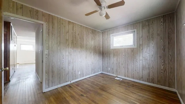 a view of empty room with wooden floor