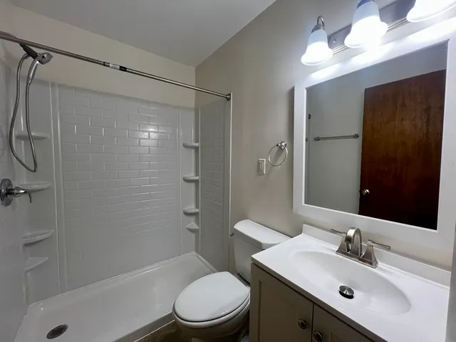 a bathroom with a sink toilet and shower