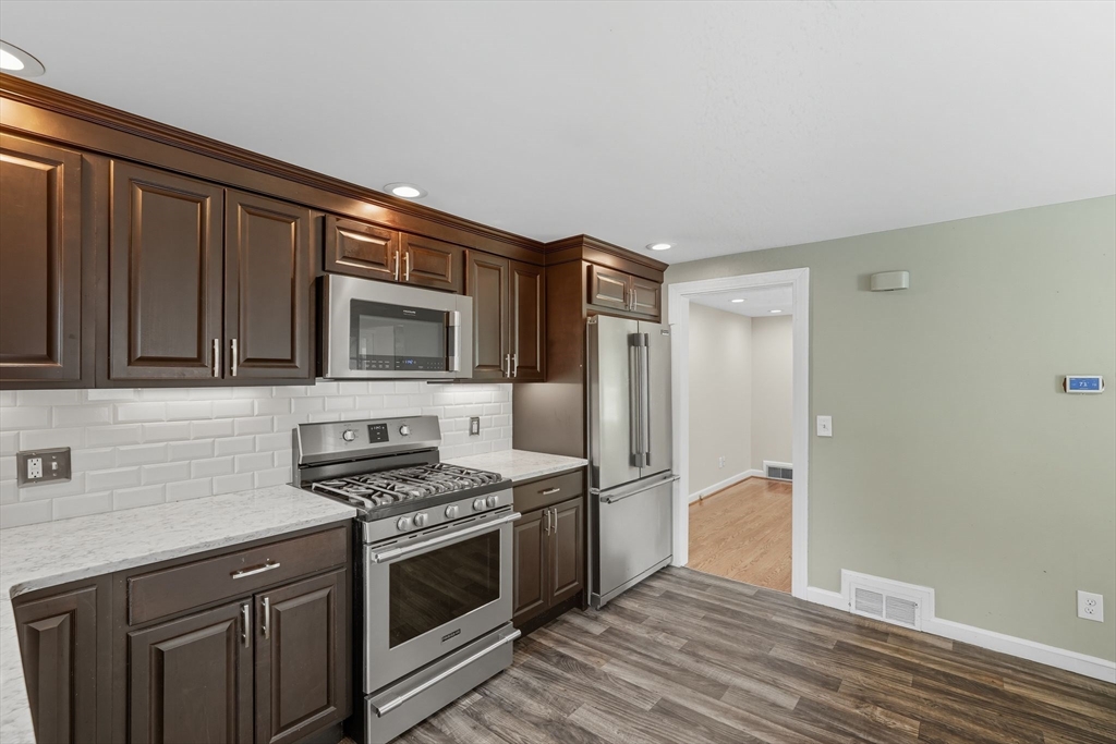 116 Hartwick Street Springfield, MA 01108 - Photo 16 of 38 a kitchen with stainless steel appliances granite countertop a stove and a refrigerator