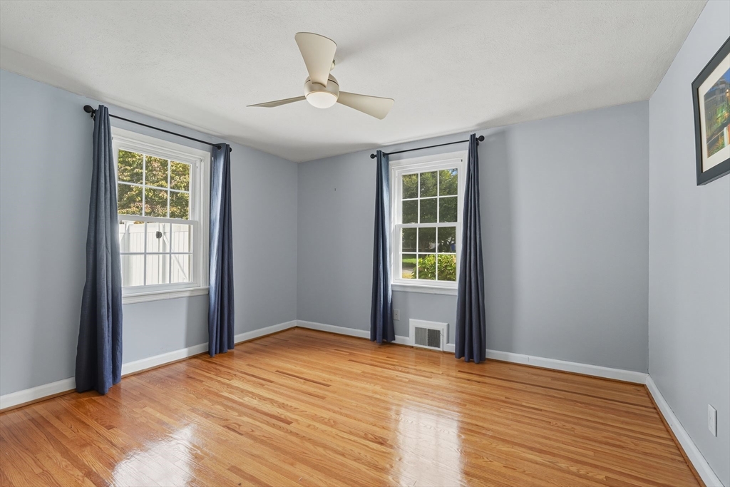 116 Hartwick Street Springfield, MA 01108 - Photo 22 of 38 a view of an empty room with a window and wooden floor