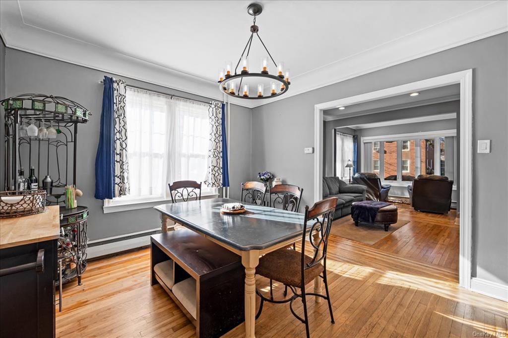 1076 Rhinelander Avenue Bronx, NY 10461 - Photo 11 of 31 a view of a dining room with furniture window and wooden floor