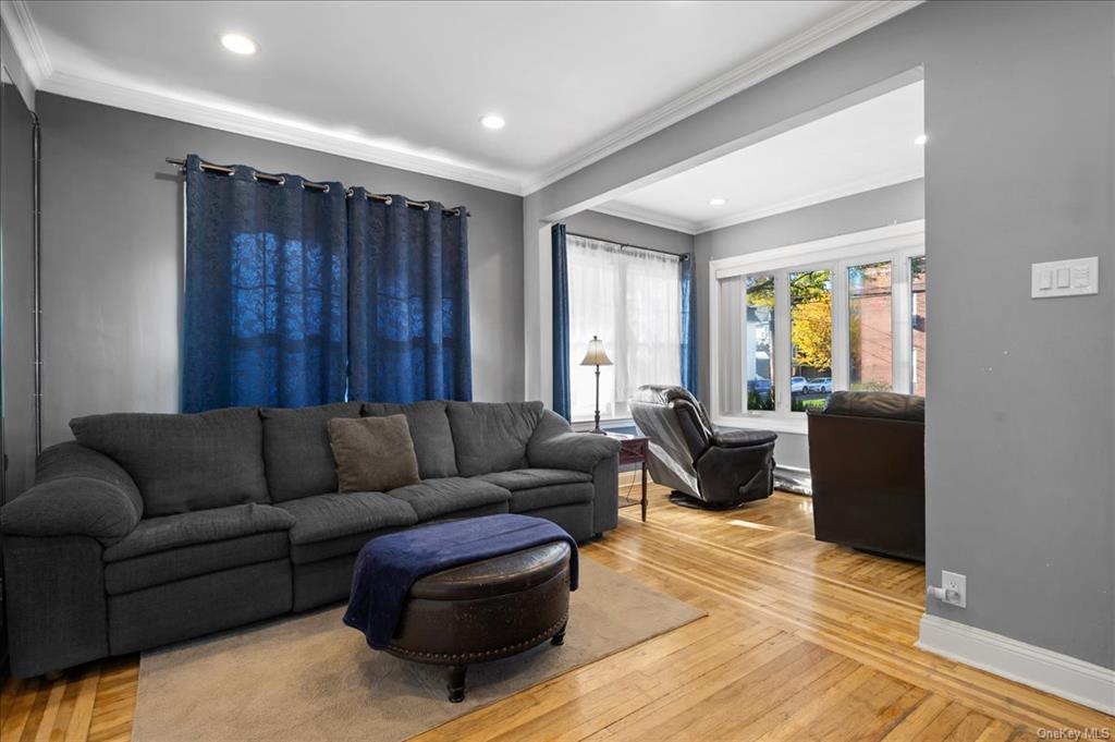 1076 Rhinelander Avenue Bronx, NY 10461 - Photo 12 of 31 a living room with furniture and a wooden floor