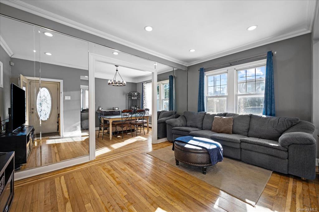 1076 Rhinelander Avenue Bronx, NY 10461 - Photo 14 of 31 a living room with furniture and a flat screen tv