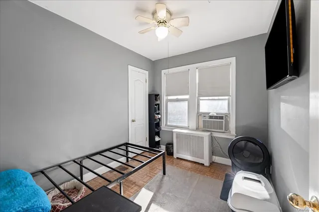 a living room with furniture a flat screen tv and a window