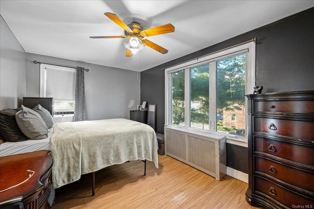 1076 Rhinelander Avenue Bronx, NY 10461 - Photo 19 of 31 a bedroom with a large bed and a large window