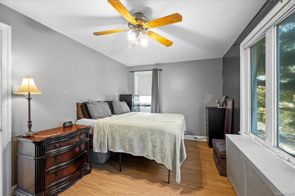 1076 Rhinelander Avenue Bronx, NY 10461 - Photo 20 of 31 a bedroom with bed and a chandelier