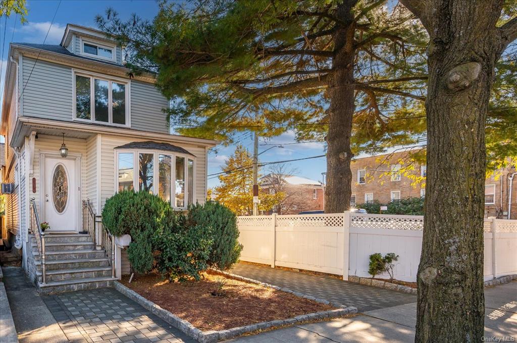 1076 Rhinelander Avenue Bronx, NY 10461 - Photo 2 of 31 a front view of a house with a tree