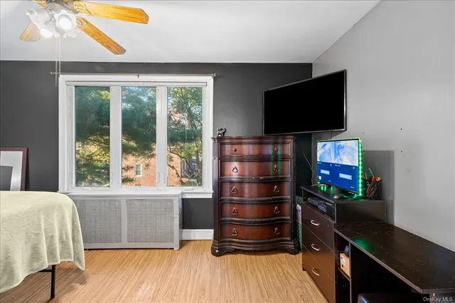 a living room with a flat screen tv and a window