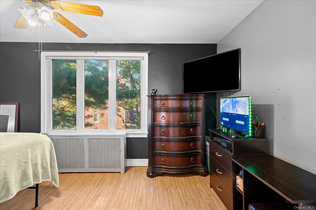 1076 Rhinelander Avenue Bronx, NY 10461 - Photo 21 of 31 a living room with a flat screen tv and a window