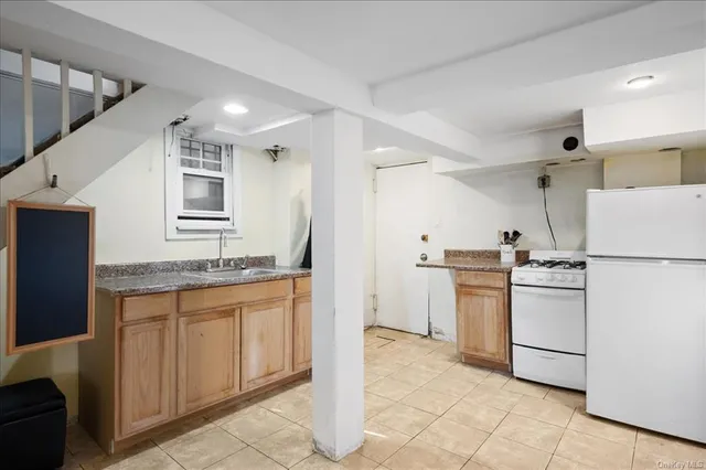 a kitchen with a sink stove and refrigerator