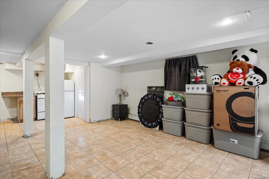 1076 Rhinelander Avenue Bronx, NY 10461 - Photo 27 of 31 a bedroom with a bed and cabinets