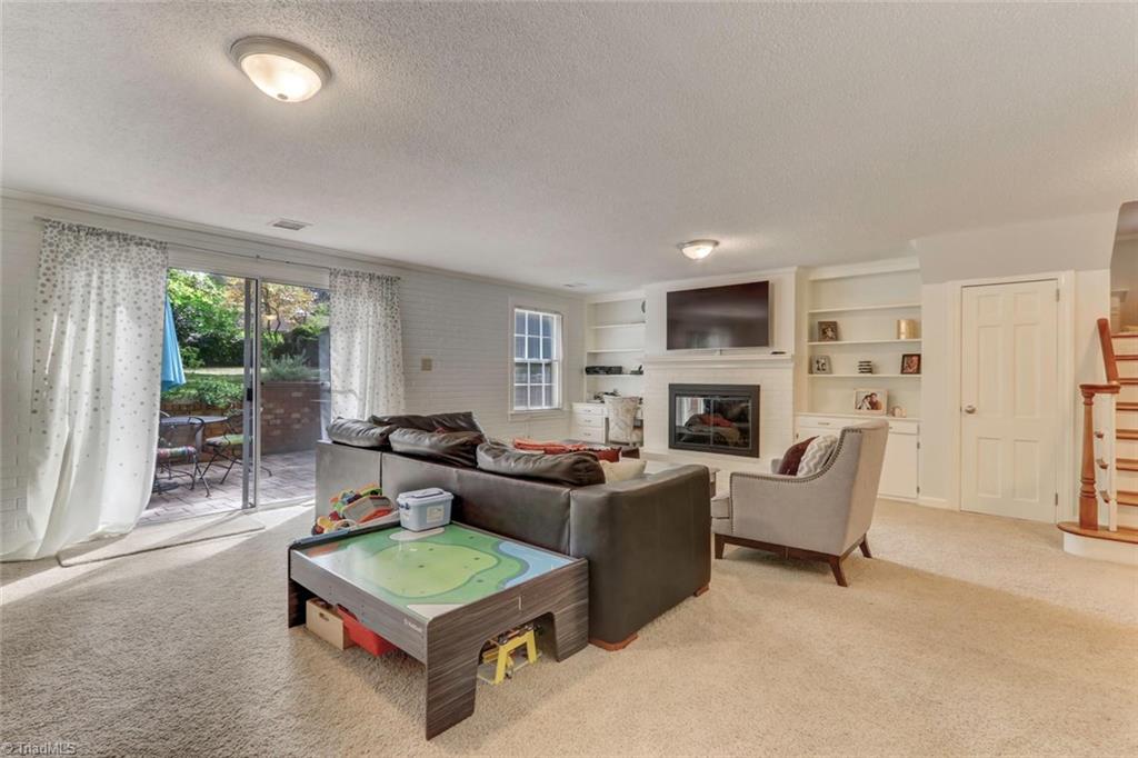 4407 Graham Road Greensboro, NC 27410 - Photo 11 of 28 Enjoy a cozy fire while entertaining family and friends.