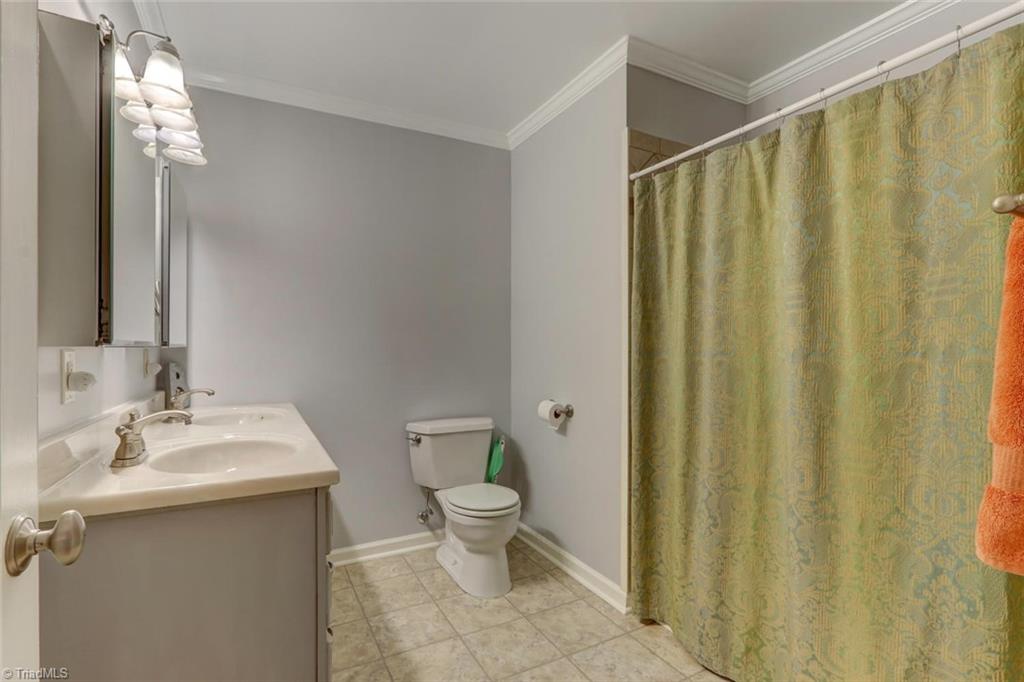4407 Graham Road Greensboro, NC 27410 - Photo 18 of 28 HUGE 2nd bath with double sink vanity. Freshly painted and crown molding for detail.