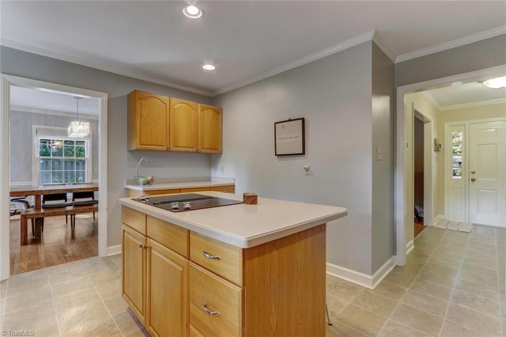4407 Graham Road Greensboro, NC 27410 - Photo 9 of 28 Kitchen island with storage and coffee bar area just beyond make this a great space!