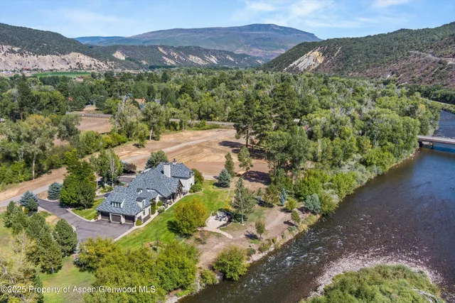 an aerial view of a house with mountain view