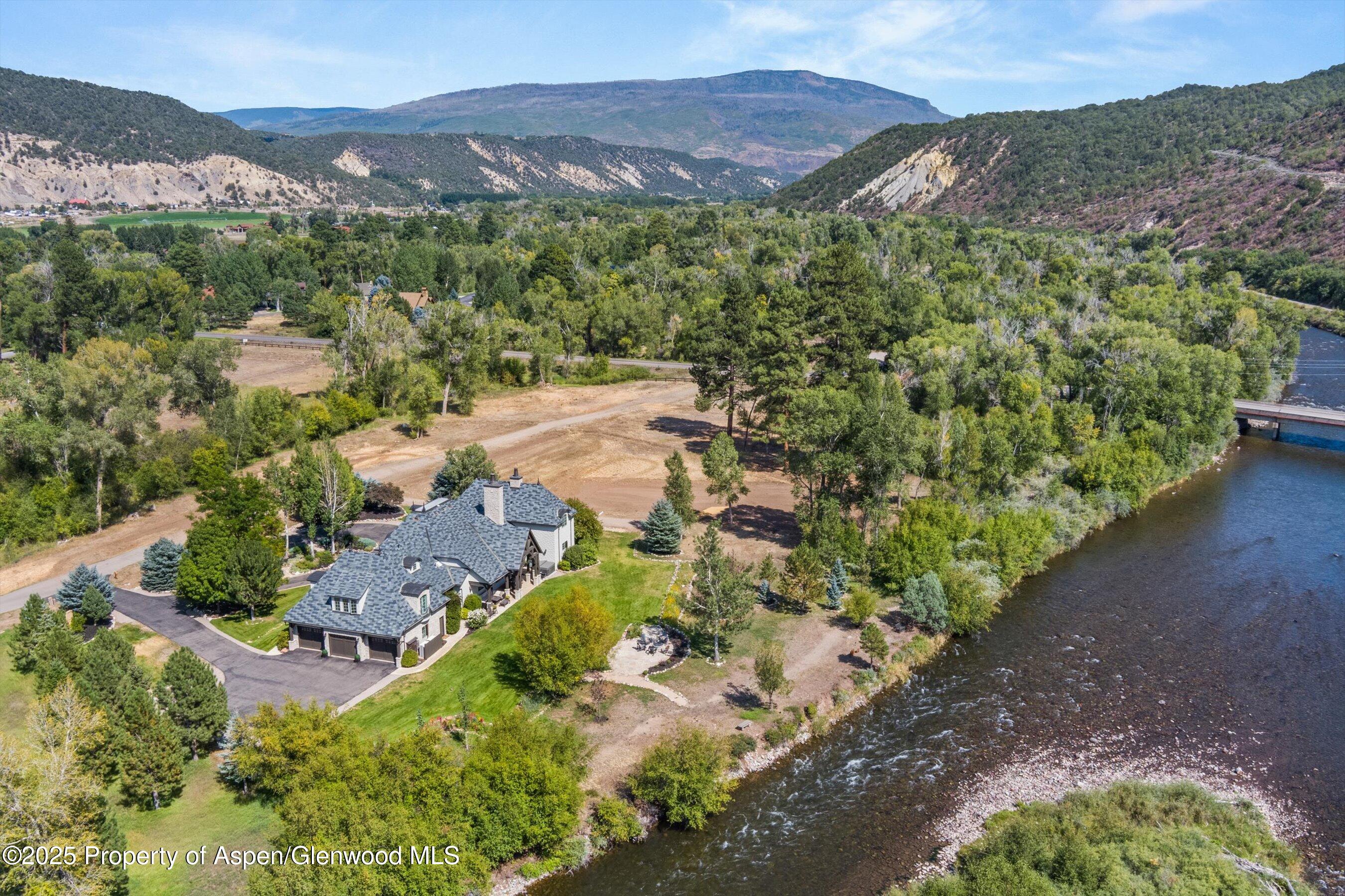an aerial view of a house with mountain view