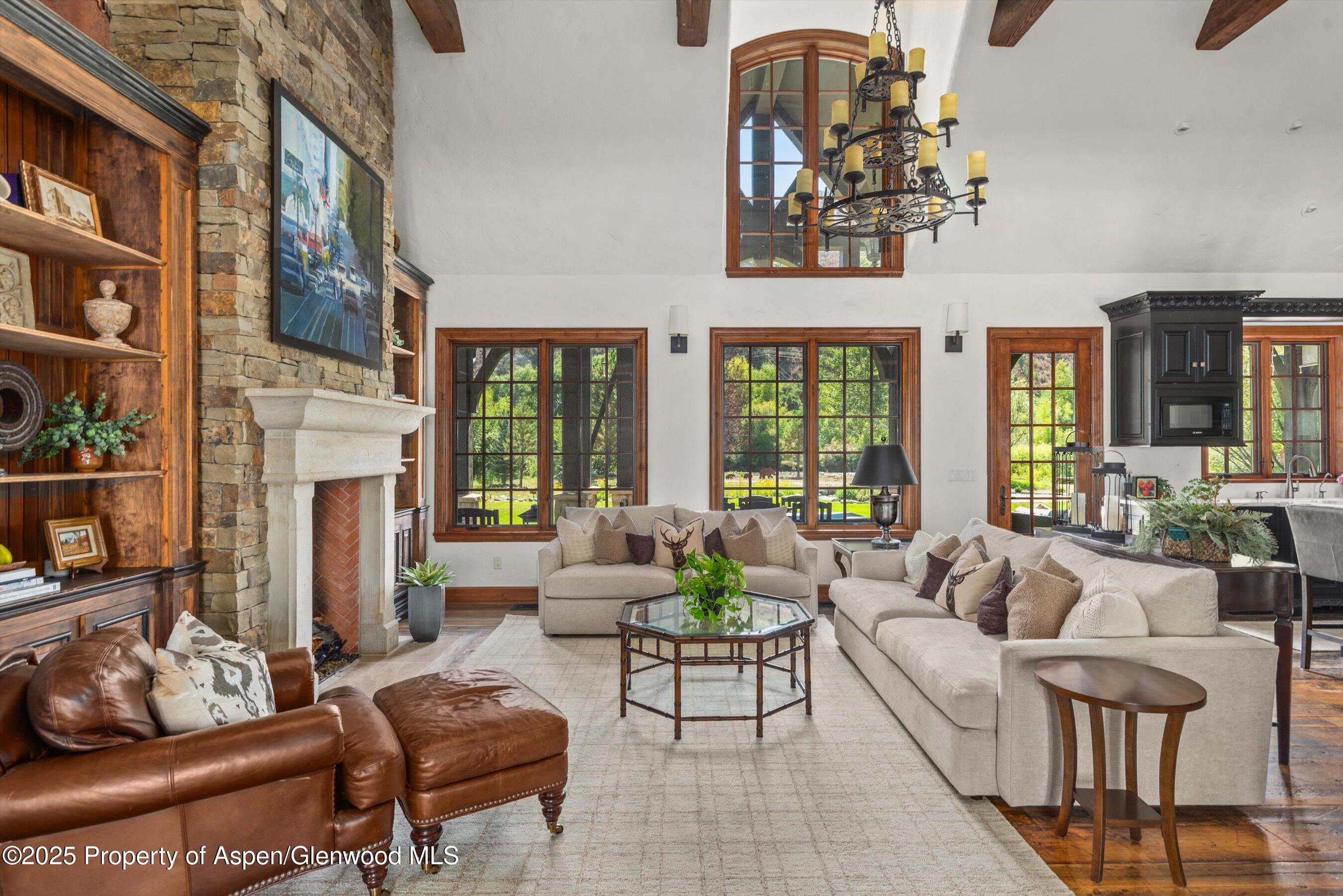 16 St Finnbar Farm Road Carbondale, CO 81623 - Photo 12 of 51 a living room with fireplace furniture and a floor to ceiling window