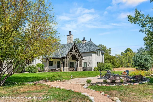 a aerial view of a house next to a yard