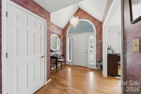 a view of a livingroom with wooden floor and furniture