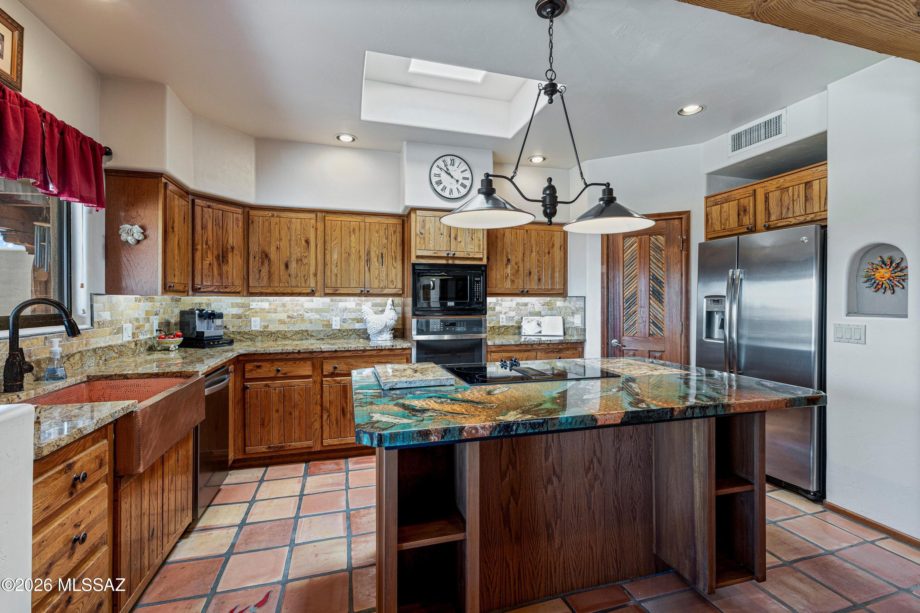11160 East Golf Links Road Tucson, AZ 85730 - Photo 14 of 51 The skylight brings ample light into this updated kitchen.