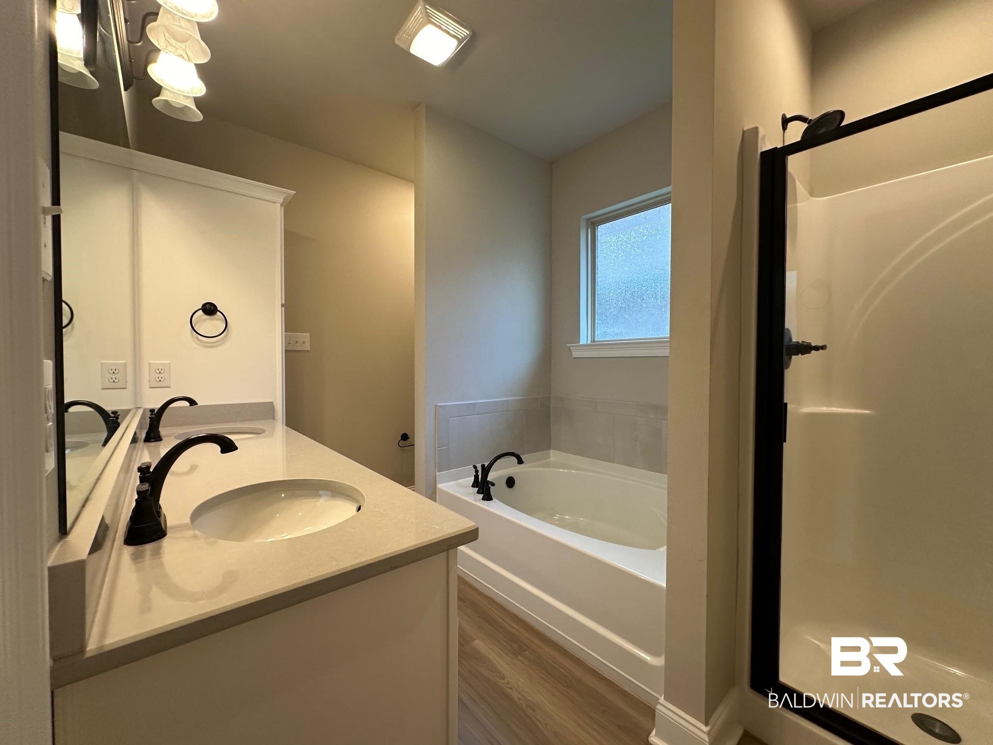 1009 Ruisseau Drive Foley, AL 36535 - Photo 42 of 55 Bathroom with vanity, wood-type flooring, and separate shower and tub