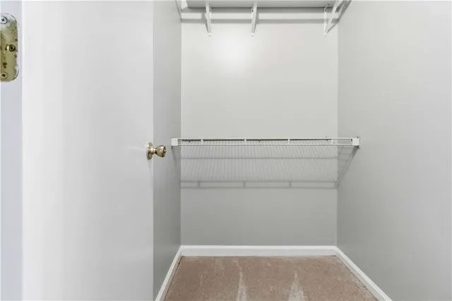 a view of walk in closet with clothes