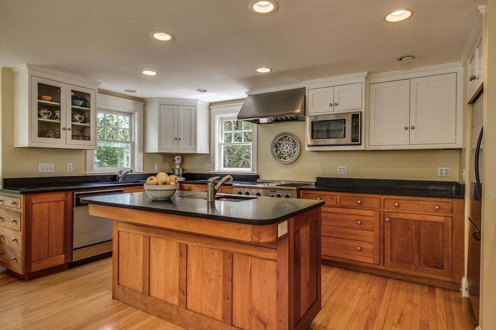 23 Slough Road Harvard, MA 01451 - Photo 2 of 30 a kitchen with kitchen island granite countertop wooden cabinets stainless steel appliances a sink and a window
