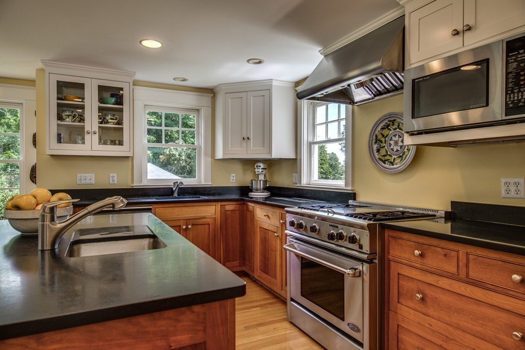 23 Slough Road Harvard, MA 01451 - Photo 8 of 30 a kitchen with a stove a microwave and cabinets