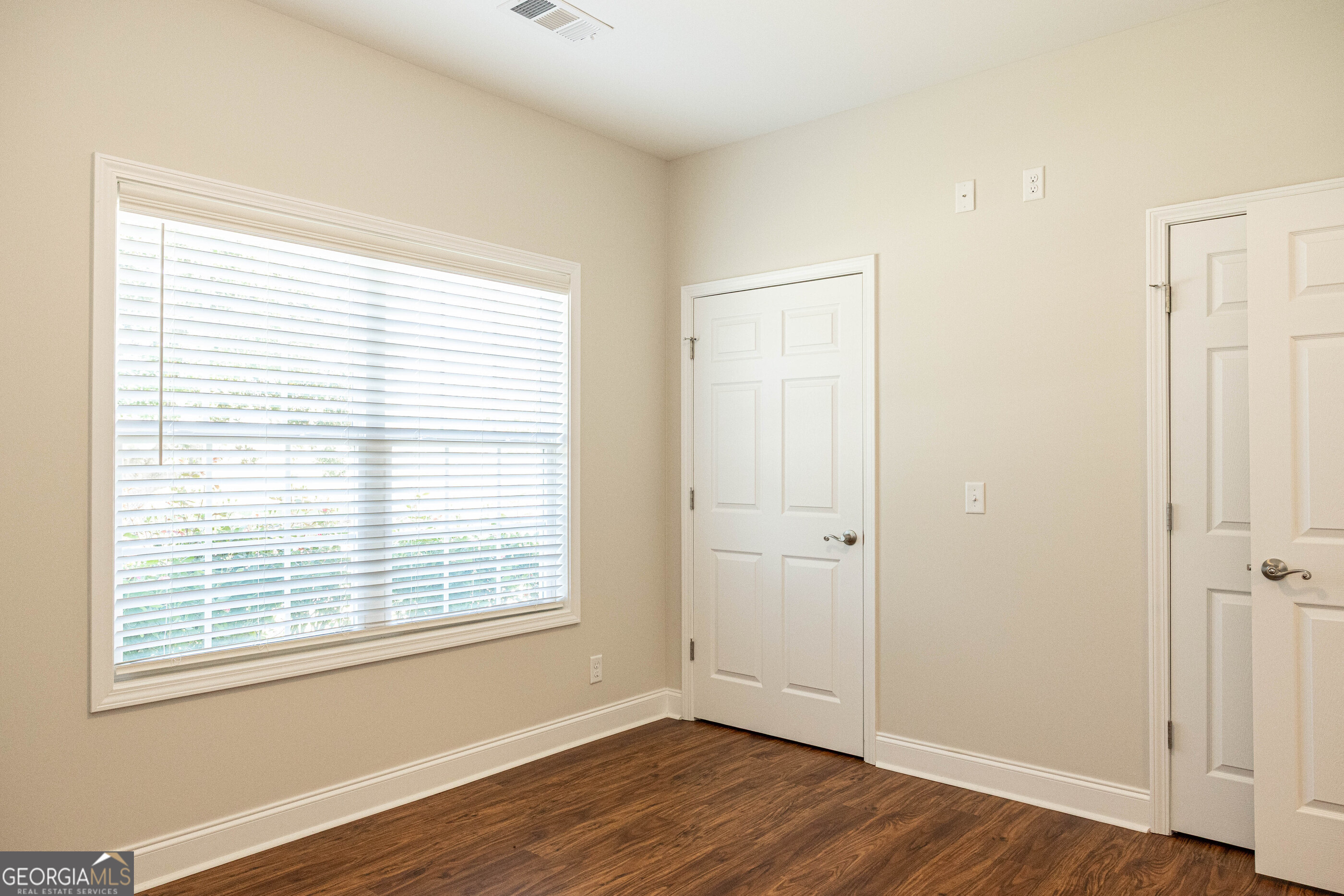 3508 23rd Drive Valley, AL 36854 - Photo 11 of 23 a view of an empty room with wooden floor and a window