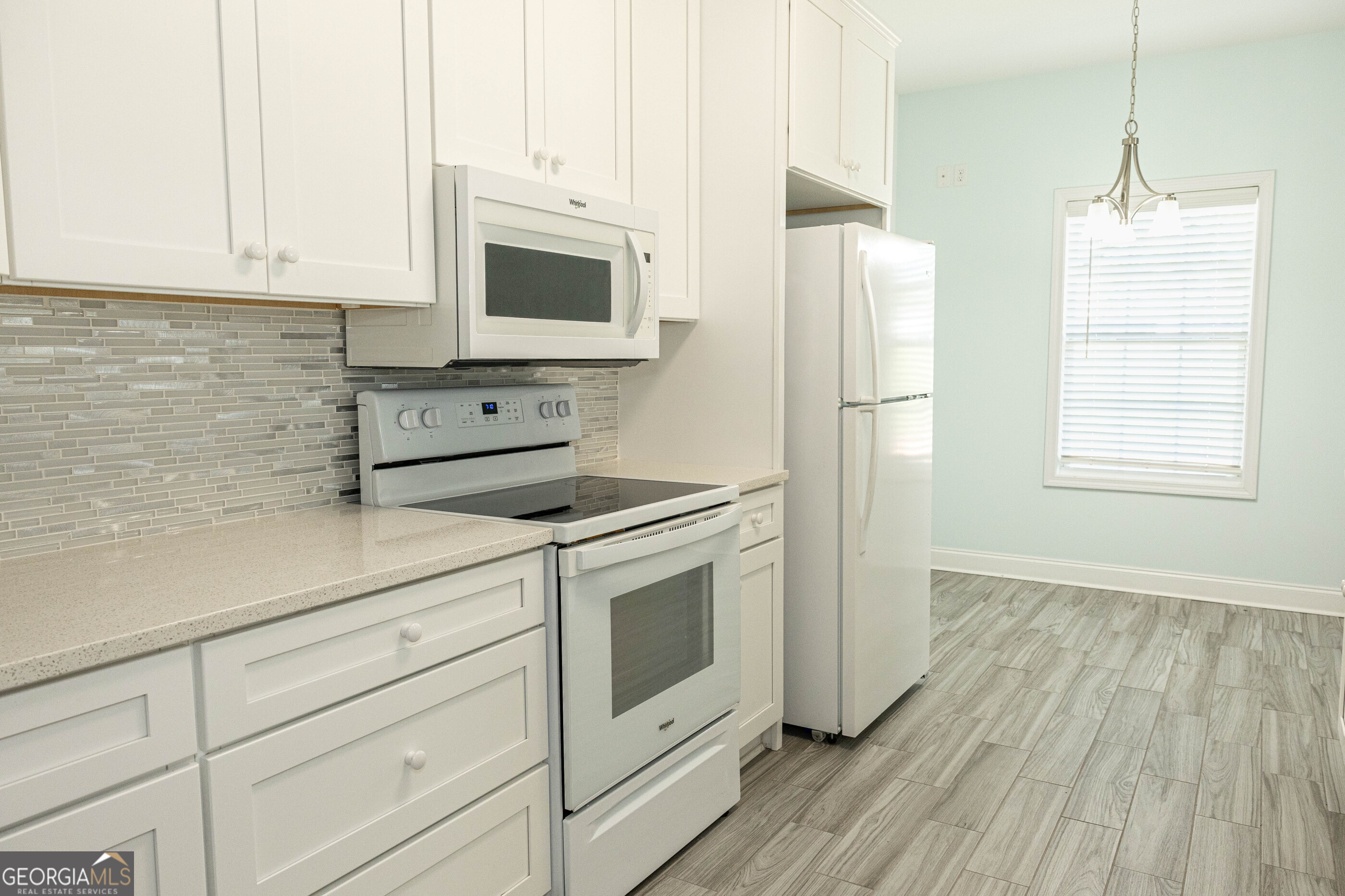 3508 23rd Drive Valley, AL 36854 - Photo 3 of 23 a kitchen with stainless steel appliances white cabinets and a wooden floor