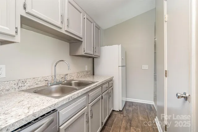 a kitchen with a sink and refrigerator
